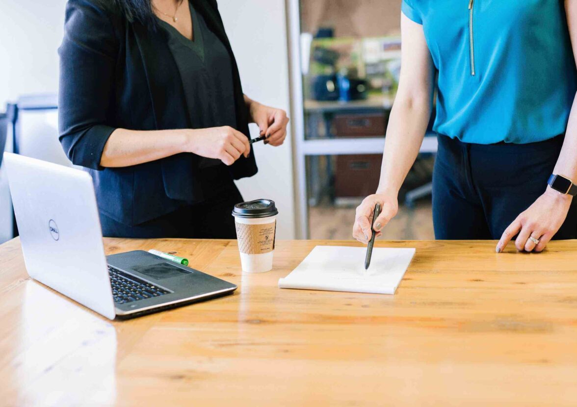 two women signing a contract