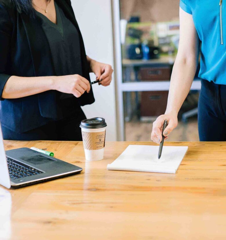 two women signing a contract